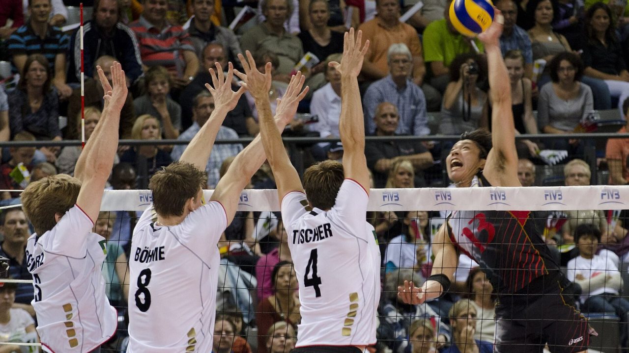 Japanese attacker Kunihiro Shimizu spiking against a German triple block at a 2011 World League match